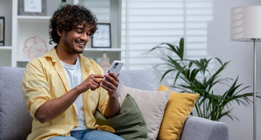 Man using a home security app on his mobile device