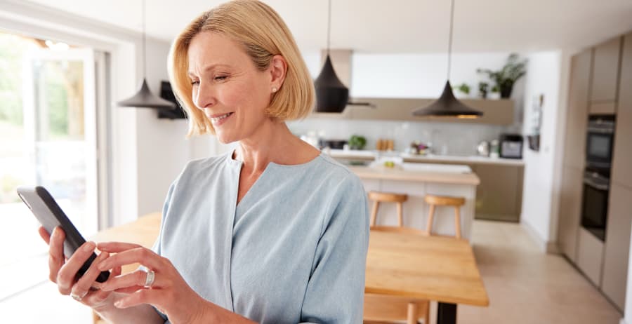 Woman with smartphone in a stylish home